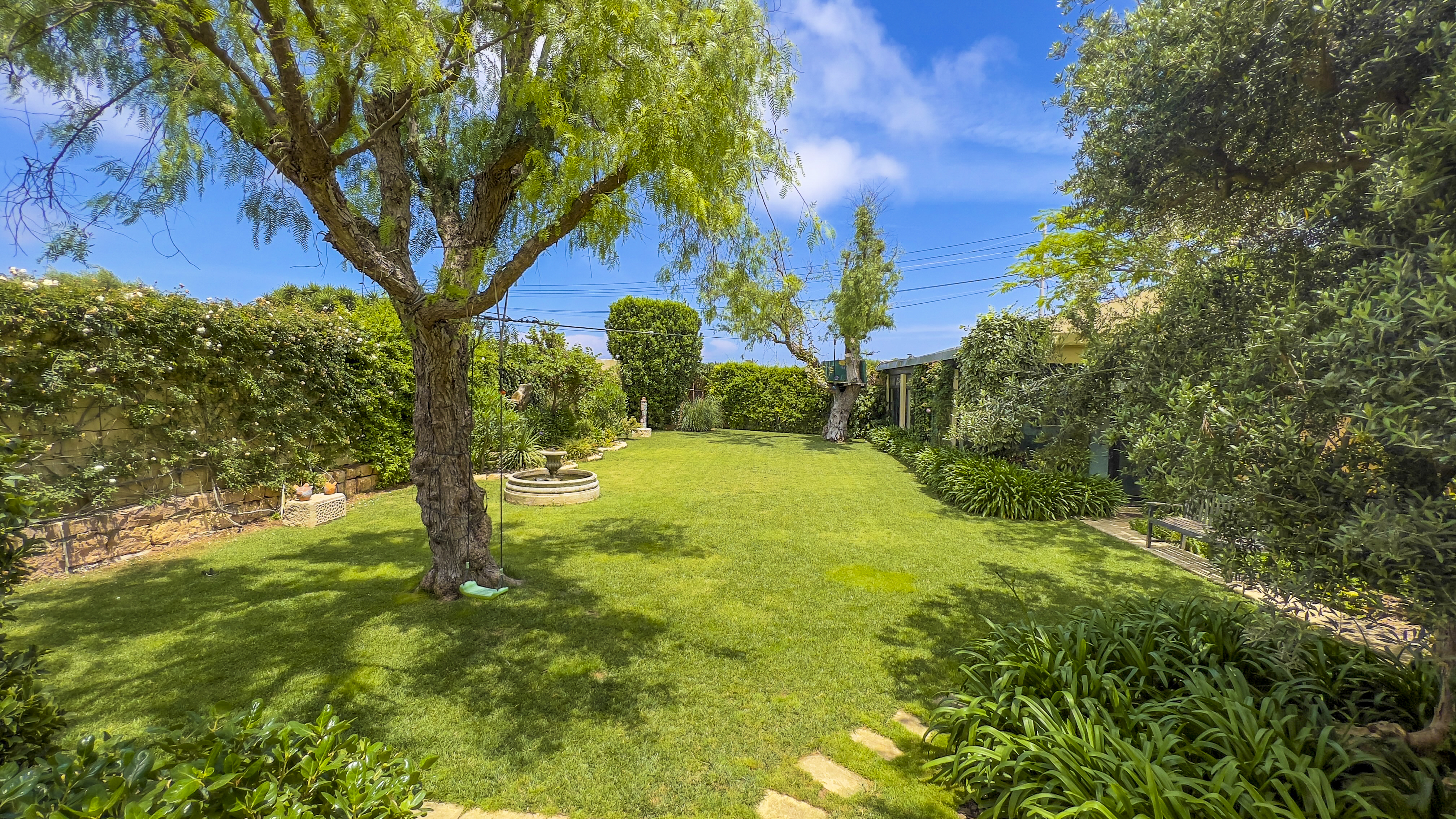 Outdoor dining table set for a wedding on the lawn at Nine Angels Villa