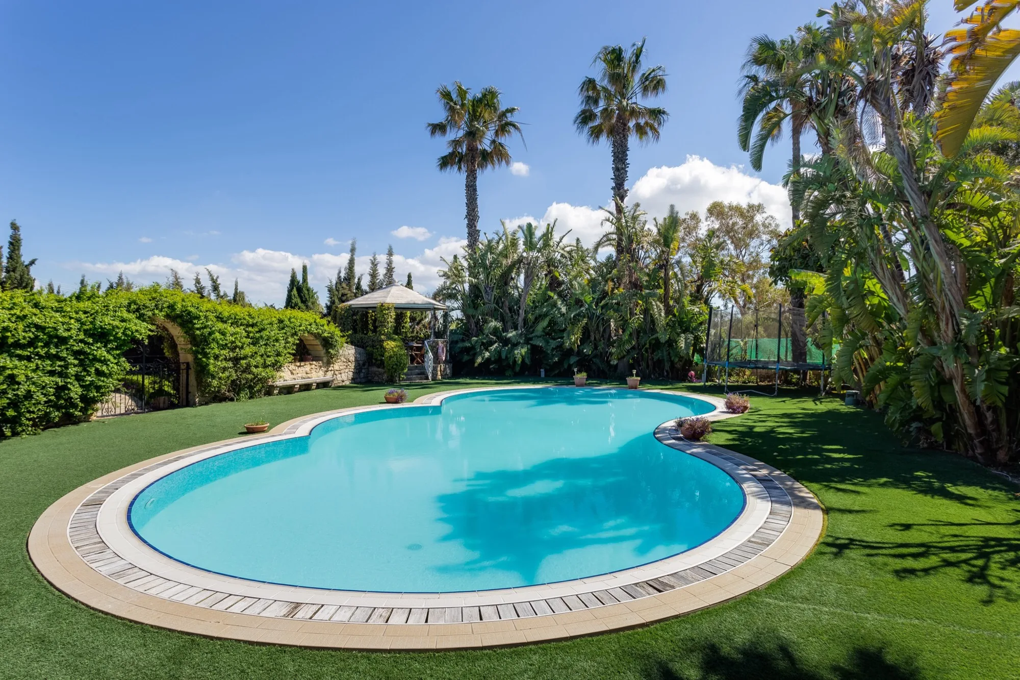 Lagoon pool at dusk with ambient lighting at Nine Angels Villa